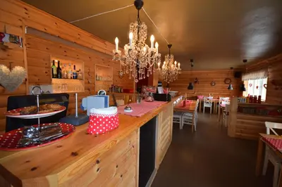 a dining room with a bar in a restaurant at Halvorseth in Prestfoss