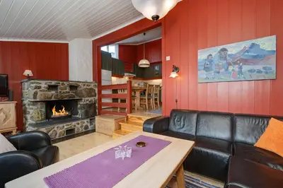 a living room with a couch and a fireplace at Bitigrenda B in Beitostøl