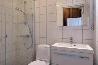a bathroom with a toilet and a sink and a shower at Bitigrenda K in Beitostøl