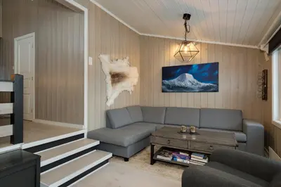 a living room with a couch and a table at Bitigrenda L in Beitostøl