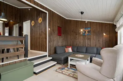a living room with a couch and a table at Bitigrenda F in Beitostøl