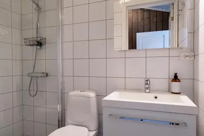 a bathroom with a toilet and a sink and a shower at Bitigrenda F in Beitostøl