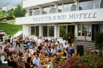 a crowd of people sitting in front of a building at Balestrand Hotel in Balestrand