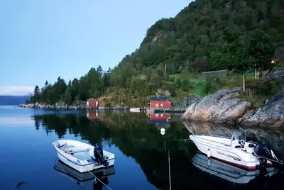 two boats are docked in a body of water at Waerholmen in Lavik