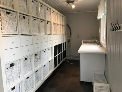 a room with white lockers and a sink and a window at Landlig idyll med fjordutsikt in Valsøybotn