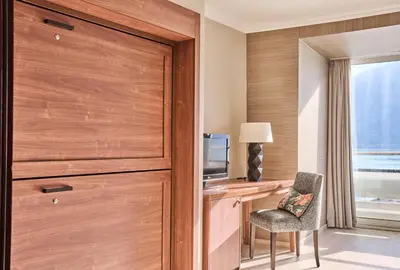 a room with a desk with a tv and a chair at Hotel Ullensvang in Lofthus