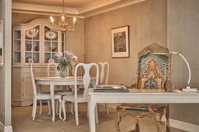 a dining room with a table and chairs and a chandelier at Hotel Ullensvang in Lofthus