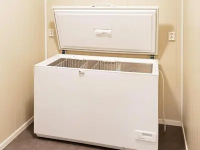 a white refrigerator freezer sitting in a room at 6 person holiday home in Oksvoll in Oksvoll