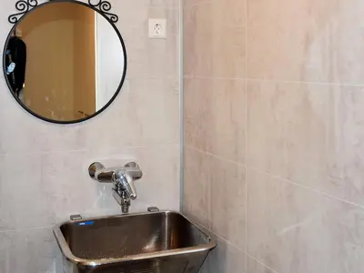 a bathroom with a sink and a mirror on the wall at 6 person holiday home in Oksvoll in Oksvoll
