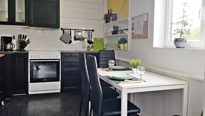 a kitchen with a table with chairs and a stove at Apartment Dreamvalley in Isfjorden