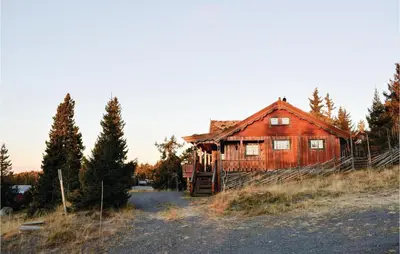 an old wooden house in the middle of a field at Two-Bedroom Holiday Home In Sjusjoen in Sjusjøen