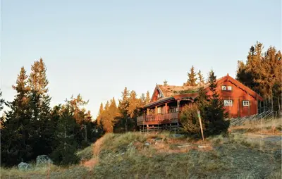 an old house in the middle of a field at Two-Bedroom Holiday Home In Sjusjoen in Sjusjøen