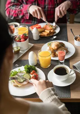 a group of people sitting at a table with plates of food at Sagafjord Hotel - by Classic Norway Hotels in Sæbø
