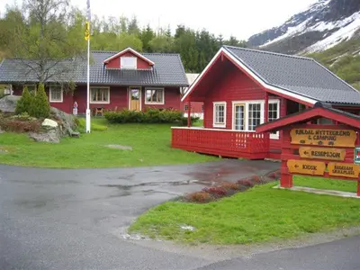 a red house with a sign in front of it at Røldal Hyttegrend & Camping in Røldal