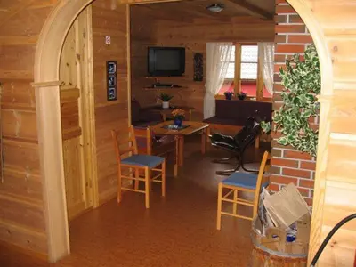 a room with chairs and a table and a television at Røldal Hyttegrend & Camping in Røldal