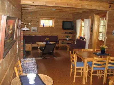 a living room with a table and a dining room at Røldal Hyttegrend & Camping in Røldal