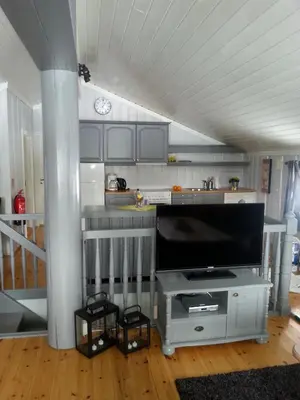 a living room with a flat screen tv on a stand at Haglebu Feriesenter in Eggedal