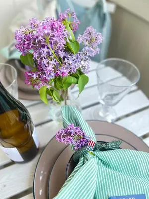 a vase filled with purple flowers on a table at Eggedal Borgerstue in Eggedal