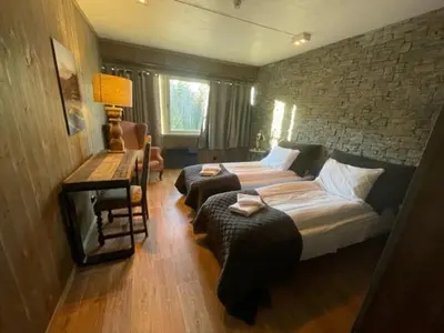 a bedroom with a bed and a table and a desk at Eggedal Borgerstue in Eggedal