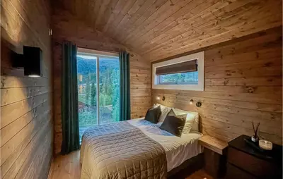 a bedroom with a bed in a room with a window at 5 Bedroom Cozy Home In Hemsedal in Hemsedal