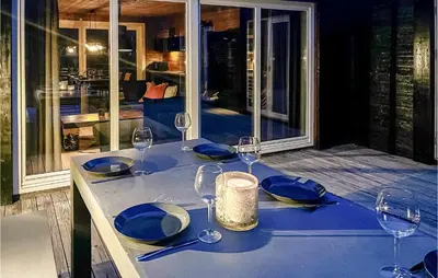 a table with wine glasses and blue plates on it at 5 Bedroom Cozy Home In Hemsedal in Hemsedal