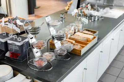 a counter with glasses of wine and a tray of food at Scandic Hønefoss in Hønefoss