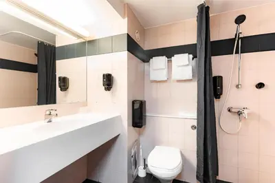 a bathroom with a sink and a toilet at Scandic Hønefoss in Hønefoss