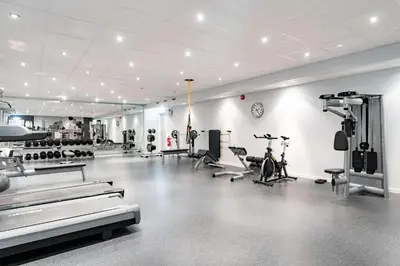 a gym with bikes and exercise equipment in a room at Scandic Hønefoss in Hønefoss