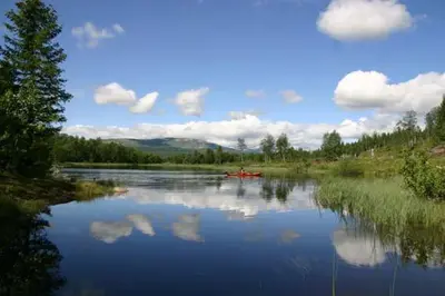 a view of a river with a boat on it at Bergfosshytta in Ron