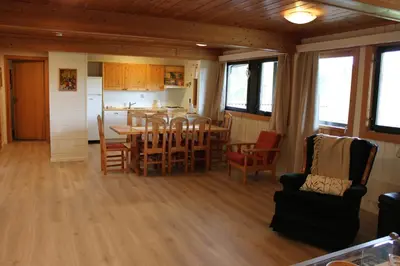 a kitchen and dining room with a table and chairs at Bergfosshytta in Ron