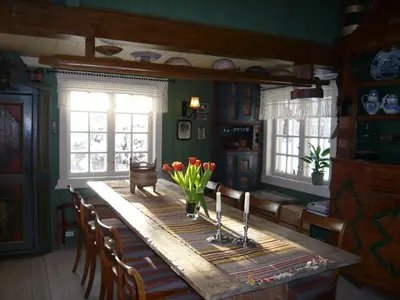 a dining room with a table with flowers on it at Hagaled Gjestegård in Nesbyen