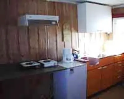 a kitchen with a white refrigerator and a counter top at Kvanhøgd Turistsenter in Gol