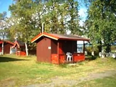 a small red shack in a field of grass at Kvanhøgd Turistsenter in Gol