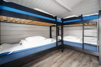 two bunk beds are in a room with wood floors at First Camp Gol Hallingdal in Gol