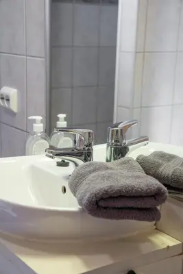 a bathroom sink with towels and a mirror at Camp Uvdal in Uvdal