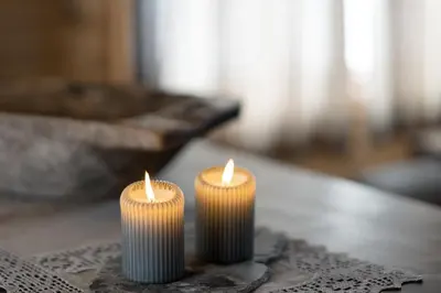 two candles sitting on top of a table at Camp Uvdal in Uvdal