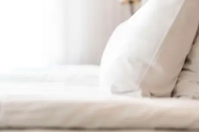 a close up of a white bed in a room at Scandic Victoria Lillehammer in Lillehammer