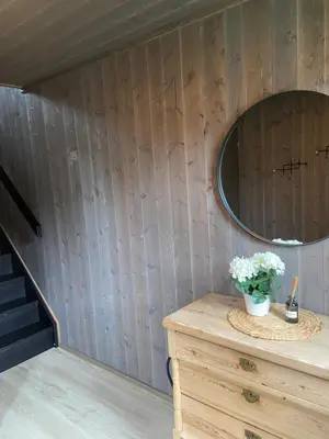a room with a dresser and a mirror on a wall at Jotunheimen Husky Lodge in Randsverk