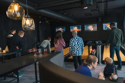 a group of people standing around a bar with televisions at Myrkdalen Resort Hotel in Myrkdalen