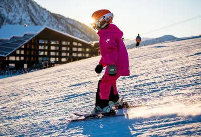 a young child is skiing down a snow covered slope at Myrkdalen Resort Hotel in Myrkdalen