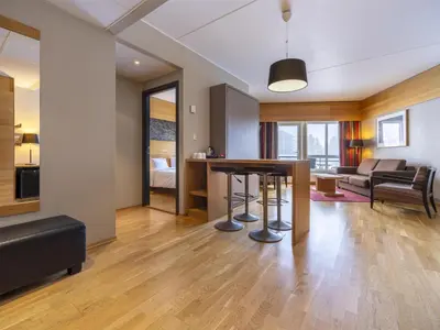 a living room with a table and a couch at Radisson Blu Resort, Trysil in Trysil
