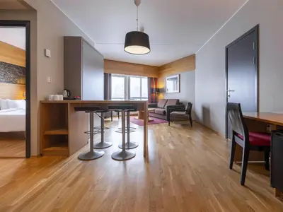 a room with a dining table and a living room at Radisson Blu Resort, Trysil in Trysil
