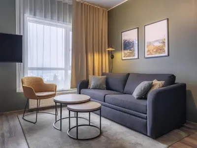 a living room with a couch and two chairs and a table at Radisson Blu Resort, Trysil in Trysil