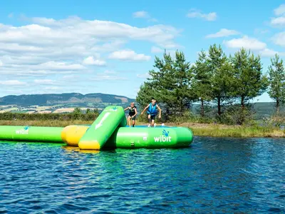 a group of people riding on an inflatable raft in the water at Sveastranda Camping in Gullor