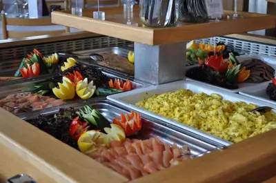 a buffet line with many different types of food at Honne Hotell in Biri