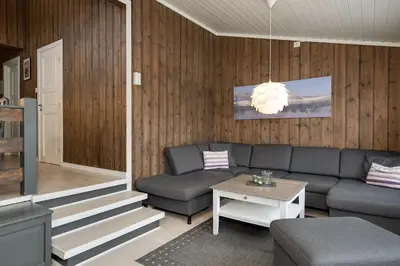 a living room with a couch and a table at Bitigrenda N in Beitostøl