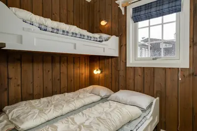a bedroom with two bunk beds and a window at Bitigrenda N in Beitostøl