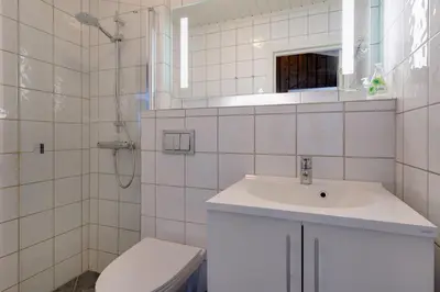 a white bathroom with a sink and a toilet at Bitigrenda N in Beitostøl