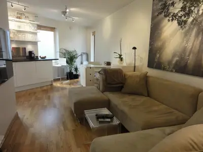 a living room with a couch and a table at Central location in the heart of historic Bergen in Bergen