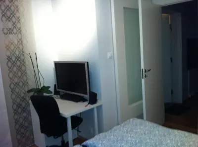 a computer monitor sitting on a desk in a bedroom at Central location in the heart of historic Bergen in Bergen